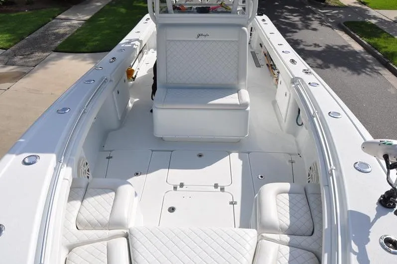 Slide: The Image of 2020 Yellowfin 32 Offshore boat interior with white cushioned seating and spacious deck. - 48