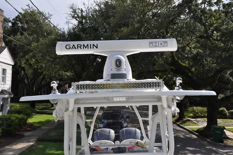 Slide: The Image of 2020 Yellowfin 32 Offshore boat with Garmin xHD2 radar, parked on a residential street. - 49