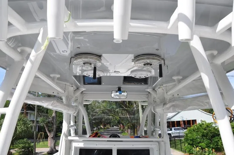 Slide: The Image of 2020 Yellowfin 32 Offshore boat interior with rod holders and speakers. - 51