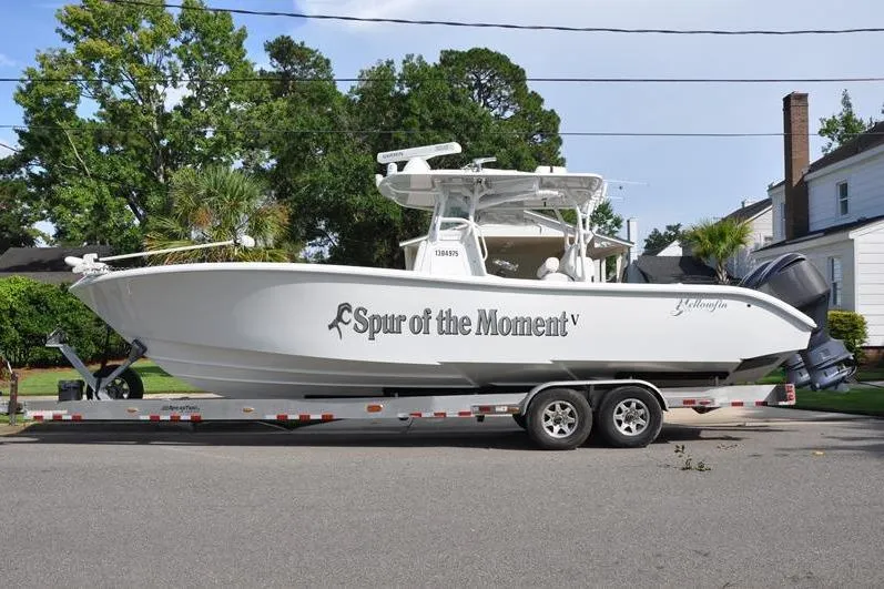 Slide: The Image of 2020 Yellowfin 32 Offshore boat on trailer, parked in residential area. - 6