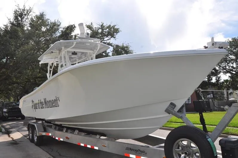Slide: The Image of 2020 Yellowfin 32 Offshore boat on trailer, parked on street. - 8