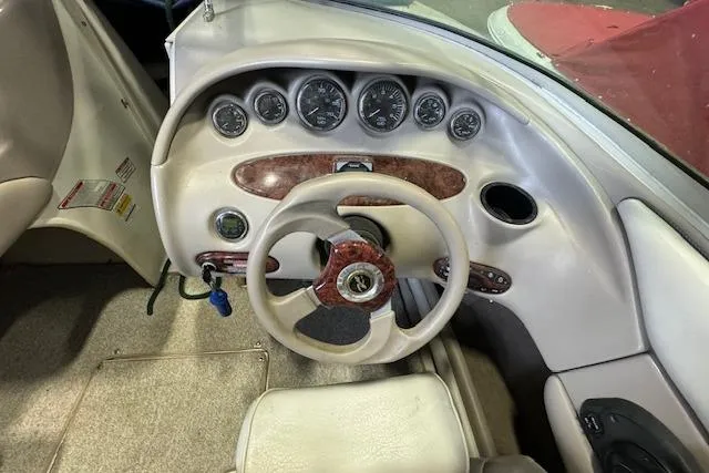 Slide: The Image of 2003 Sea Ray 220 Bow Rider dashboard with steering wheel and instrument panel. - 3