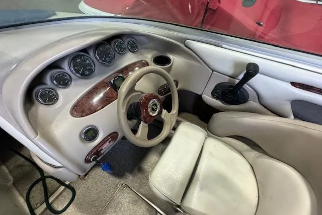 Slide: The Image of 2003 Sea Ray 220 Bow Rider dashboard with steering wheel and instrument panel. - 4
