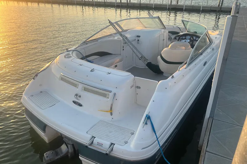 Slide: The Image of 2001 Chaparral Sunesta 233 boat docked at sunset, showcasing sleek design and spacious interior. - 3