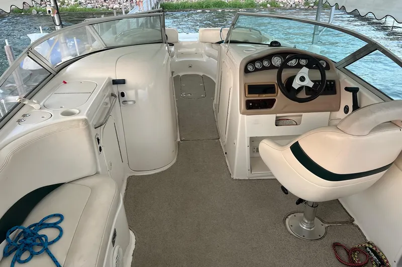 Slide: The Image of 2001 Chaparral Sunesta 233 boat interior with steering wheel and seating area. - 4