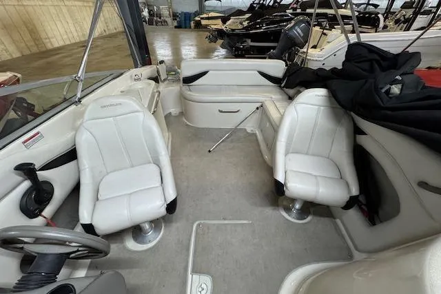 Slide: The Image of Interior of 2001 Crownline 230 BR boat with white seating and steering wheel. - 3