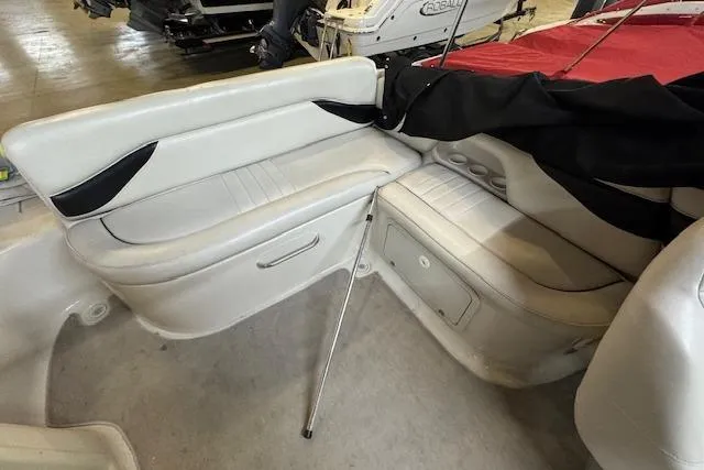 Slide: The Image of 2001 Crownline 230 BR boat interior with white seating and storage compartments. - 5