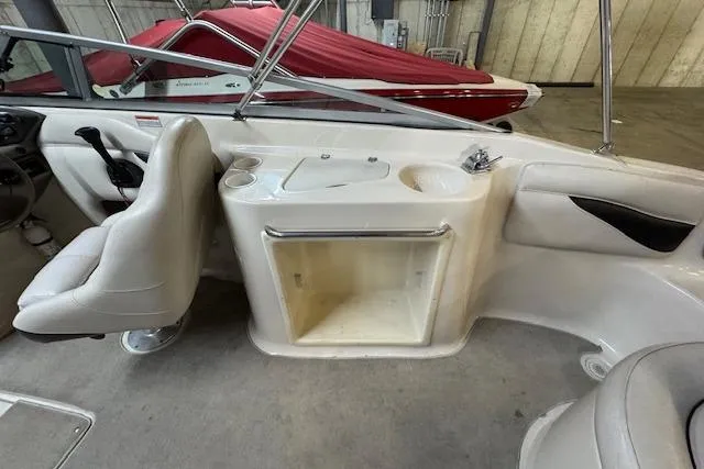 Slide: The Image of 2001 Crownline 230 BR boat interior with seating and storage compartments. - 6