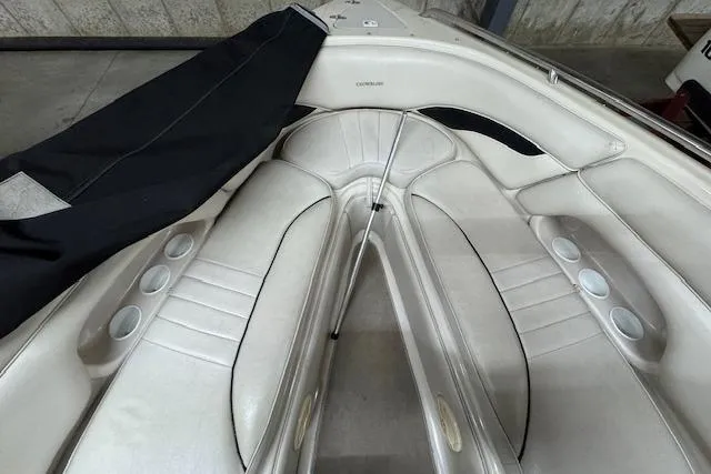 Slide: The Image of 2001 Crownline 230 BR boat interior with white seating and cup holders. - 7