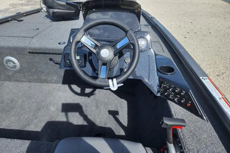 Slide: The Image of 2023 Lowe Stinger 178 boat cockpit with steering wheel and control panel. - 12