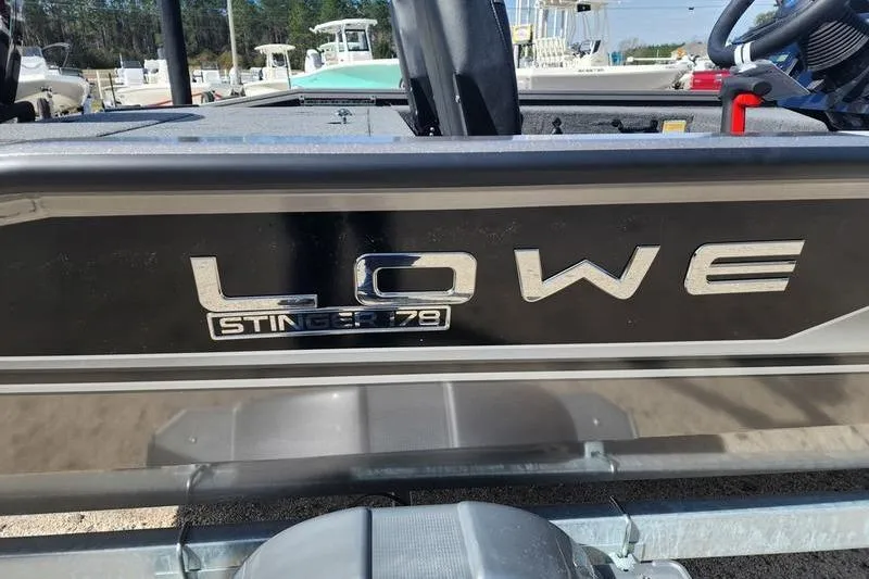 Slide: The Image of 2023 Lowe Stinger 178 boat, close-up of logo and model name on the side. - 7