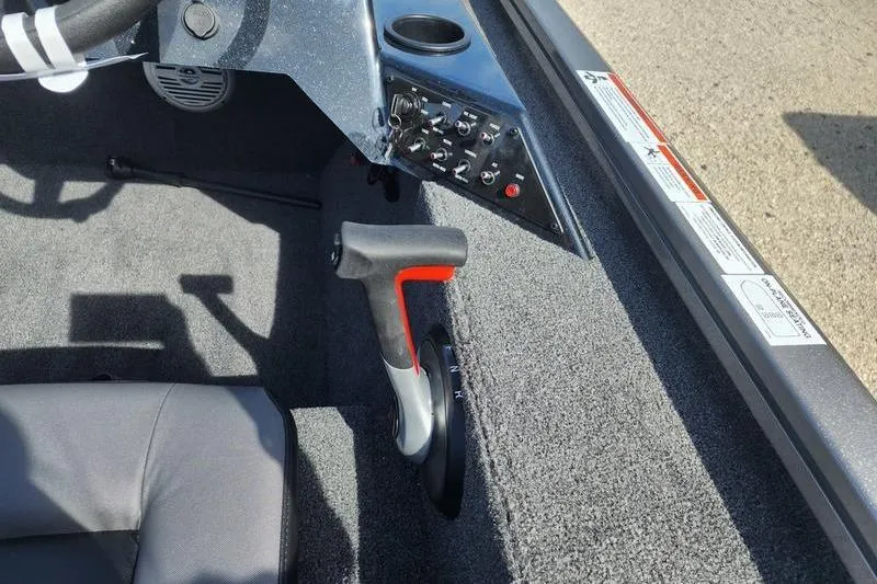 Slide: The Image of 2023 Lowe Stinger 178 boat interior with control panel and throttle lever. - 8