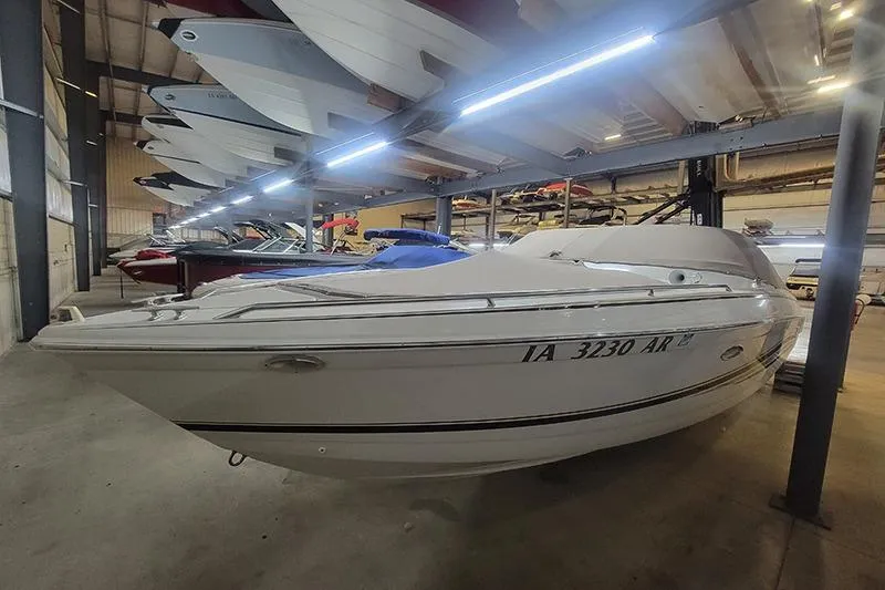 Slide: The Image of 2000 Formula 260 Bowrider boat stored indoors, surrounded by other boats. - 2