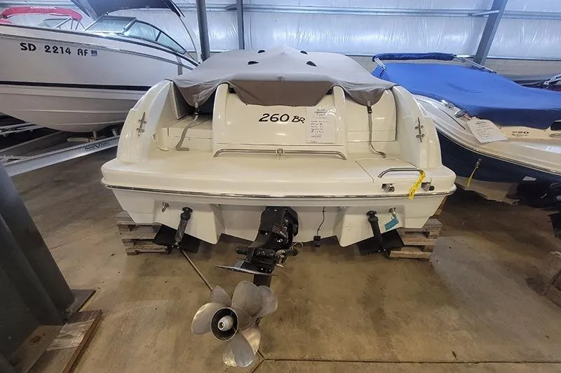 Slide: The Image of 2000 Formula 260 Bowrider boat in storage, rear view with covered seating. - 3