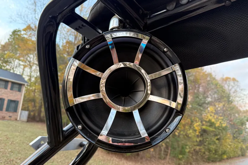 Slide: The Image of Close-up of a speaker on a 2022 Moomba Mojo boat, outdoors with trees in background. - 10