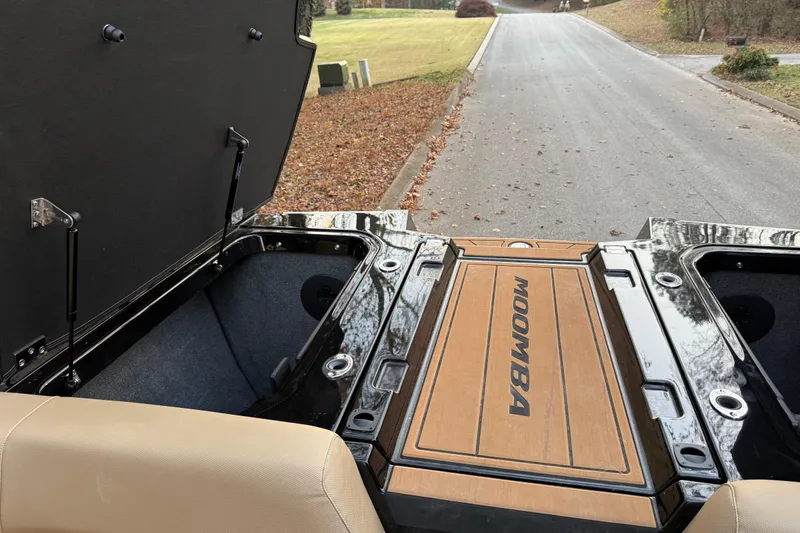 Slide: The Image of 2022 Moomba Mojo boat storage compartments open on a quiet road. - 11