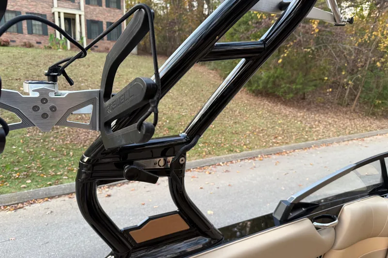 Slide: The Image of 2022 Moomba Mojo boat tower with Roswell wakeboard rack, parked near a residential area. - 14