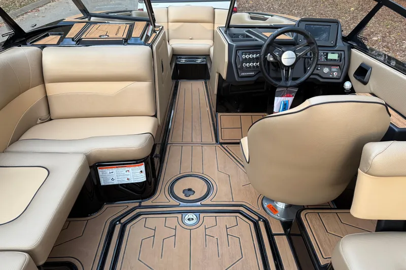 Slide: The Image of 2022 Moomba Mojo boat interior with beige seating and modern dashboard design. - 15