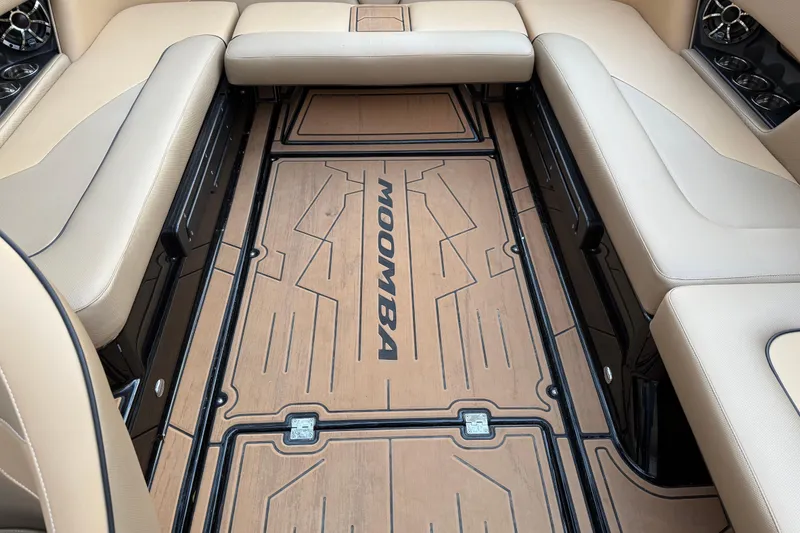 Slide: The Image of 2022 Moomba Mojo boat interior with beige seating and custom flooring design. - 18