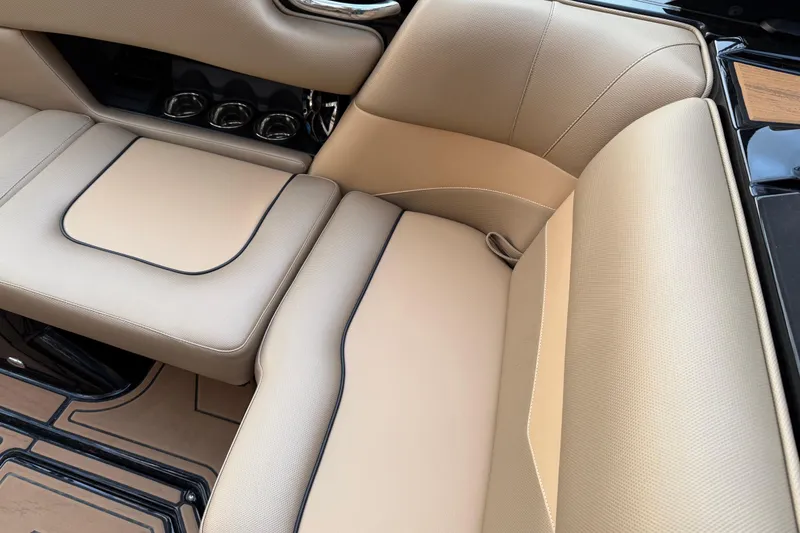 Slide: The Image of 2022 Moomba Mojo boat interior with beige leather seating and cup holders. - 19