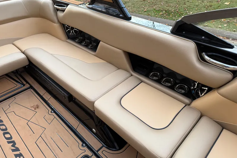 Slide: The Image of 2022 Moomba Mojo boat interior with beige seating and cup holders. - 20