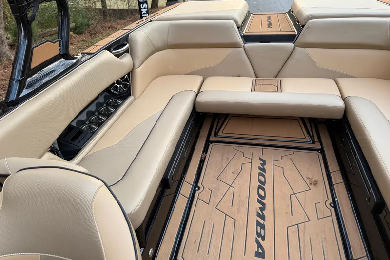 Slide: The Image of 2022 Moomba Mojo boat interior with beige seating and stylish flooring. - 22