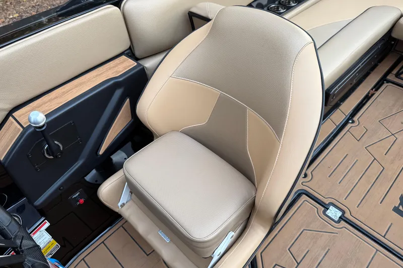 Slide: The Image of 2022 Moomba Mojo boat interior with beige seating and wood accents. - 23