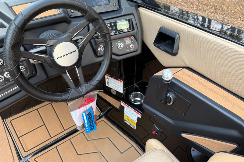 Slide: The Image of 2022 Moomba Mojo boat interior with steering wheel and control panel. - 24