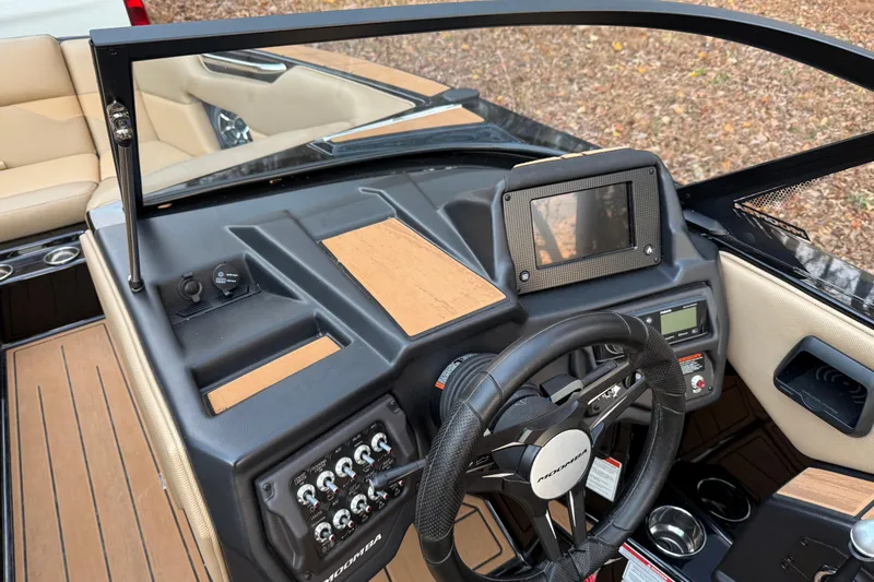 Slide: The Image of 2022 Moomba Mojo boat dashboard with steering wheel and control panel. - 25