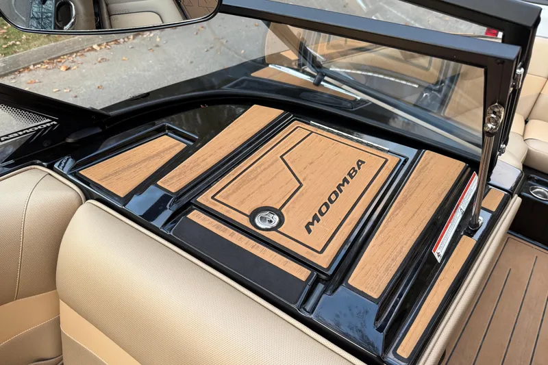 Slide: The Image of 2022 Moomba Mojo boat interior with tan and black accents, featuring Moomba branding. - 26