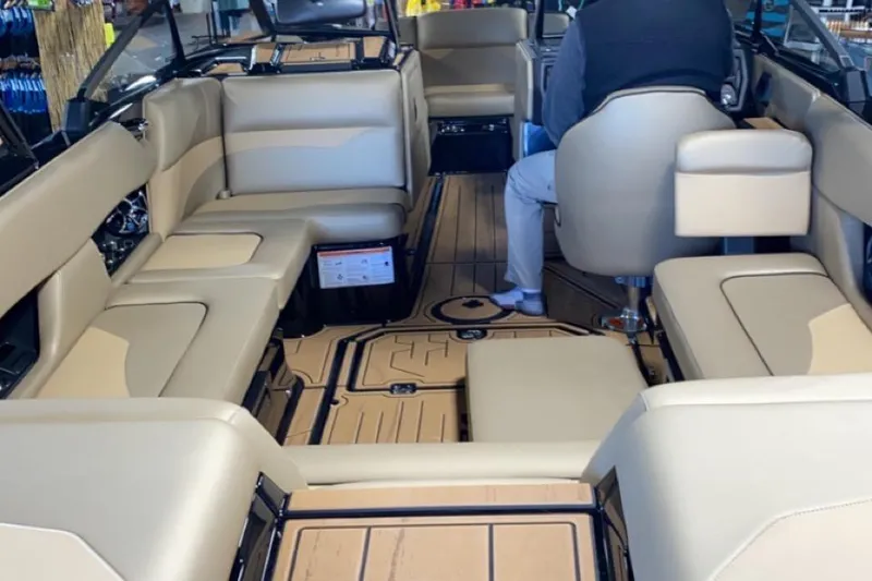 Slide: The Image of 2022 Moomba Mojo boat interior with beige seating and modern design. - 8