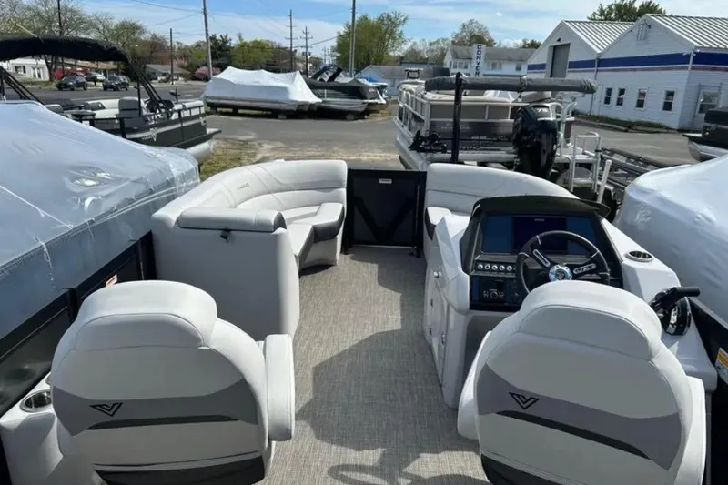 Slide: The Image of 2023 Viaggio D23U pontoon boat interior with plush seating and modern dashboard. - 11