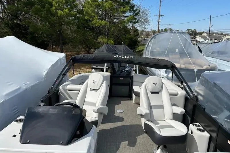 Slide: The Image of 2023 Viaggio D23U boat with white seating and canopy, parked outdoors. - 8