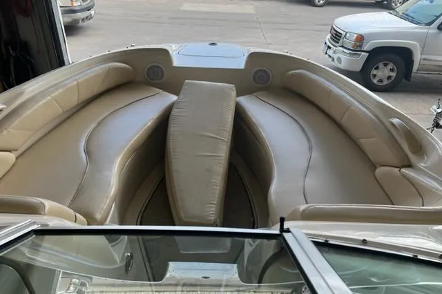 Slide: The Image of 1999 Sea Ray 210 Sundeck boat interior with beige seating and center cushion. - 3