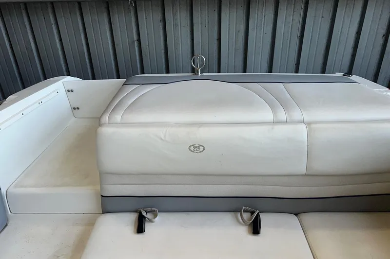 Slide: The Image of 1999 Cobalt 206 boat interior with white cushioned seating and metal railing. - 3