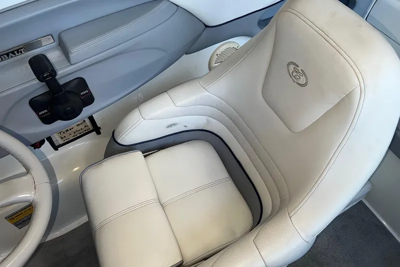 Slide: The Image of White leather seat in a 1999 Cobalt 206 boat interior. - 4