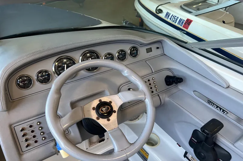 Slide: The Image of 1999 Cobalt 206 boat dashboard with steering wheel and instrument panel. - 5