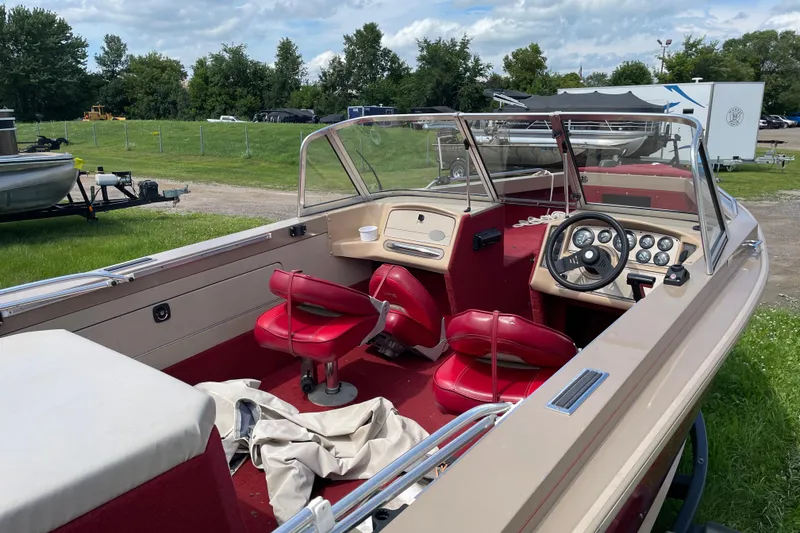 Slide: The Image of Interior of a 1998 Lund 1800 Fisherman ITS boat with red seating and dashboard. - 10
