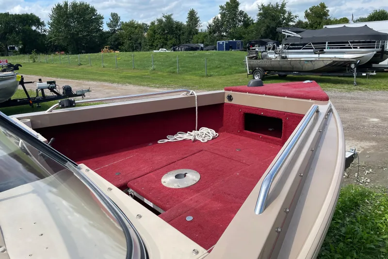 Slide: The Image of 1998 Lund 1800 Fisherman ITS boat interior with red seating and carpet. - 11