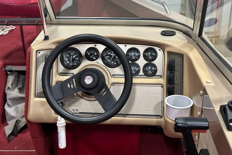 Slide: The Image of Dashboard of a 1998 Lund 1800 Fisherman ITS boat with steering wheel and gauges. - 16