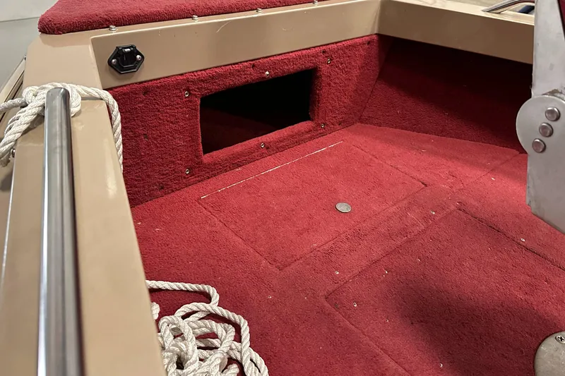 Slide: The Image of Interior of 1998 Lund 1800 Fisherman ITS boat with red carpet and storage compartment. - 19