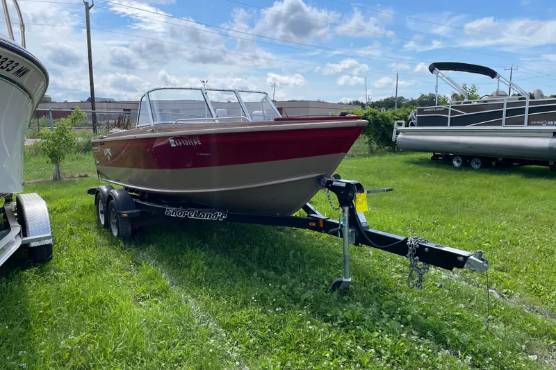 Slide: The Image of 1998 Lund 1800 Fisherman ITS boat on ShoreLand'r trailer in showroom. - 2