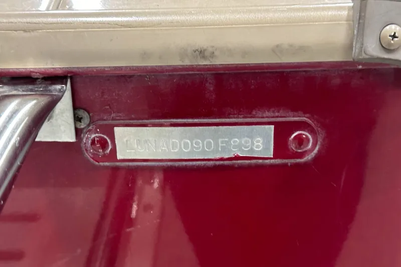 Slide: The Image of VIN plate on a 1998 Lund 1800 Fisherman ITS boat, red background. - 20