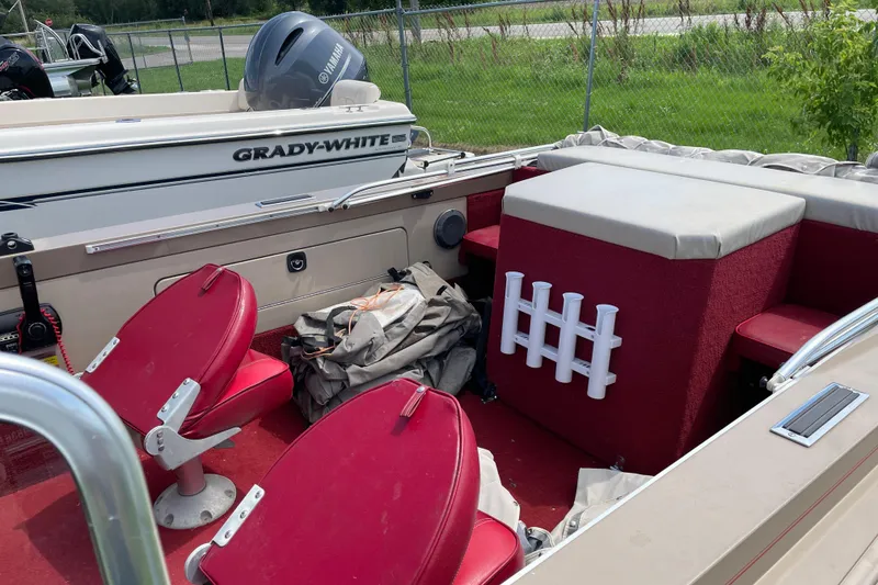 Slide: The Image of 1998 Lund 1800 Fisherman ITS boat interior with red seats and steering console. - 8