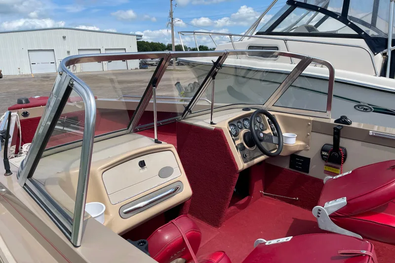 Slide: The Image of 1998 Lund 1800 Fisherman ITS boat interior with red seating and storage area. - 9