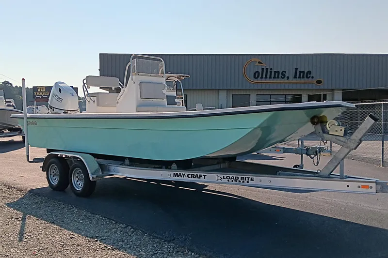 Slide: The Image of 2023 May-Craft 22 Hancock Skiff on trailer with Suzuki outboard motor. - 2