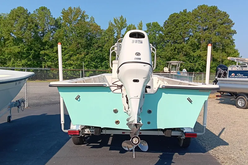 Slide: The Image of 2023 May-Craft 22 Hancock Skiff with Suzuki outboard motor, parked near a serene pond. - 4