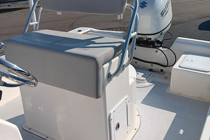 Slide: The Image of 2023 May-Craft 22 Hancock Skiff boat with spacious deck and seating, parked outdoors. - 9