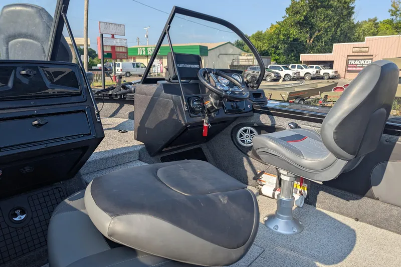 Slide: The Image of 2023 Tracker Targa V-19 Combo Tournament Edition boat interior with steering wheel and seating. - 18