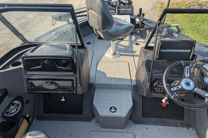Slide: The Image of 2023 Tracker Targa V-19 Combo Tournament Edition boat interior with steering wheel and electronics. - 19